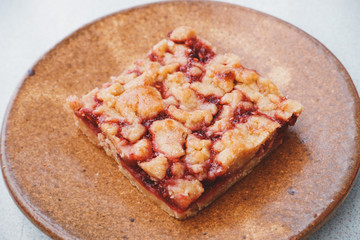 Homemade raspberry crumble bar on plate