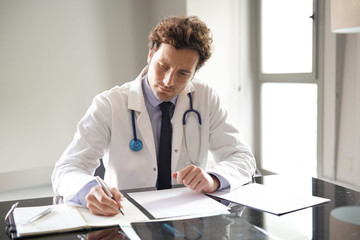 Portrait of doctor writing its conclusions about diagnosis