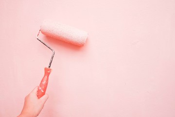 Painter paints pink wall