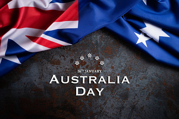 Fototapeta na wymiar Australia day concept. Australian flag with the text Happy Australia day against a black stone texture background. 26 January.