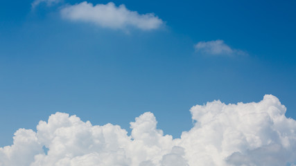 fluffy white cloud above clear blue sky background