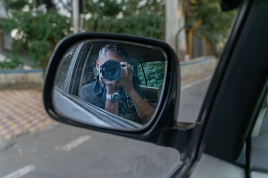 Photographer travelling, exploring and taking pictures with reflection in the mirror