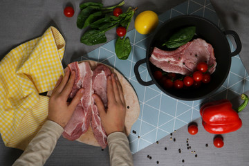 piece of appetizer fresh meat for steak with spaces, greens and vegetables isolated on the table