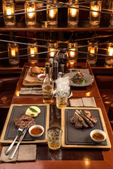 Gourmet meals assorted set on wooden table Buffet at restaurant with light bulbs
