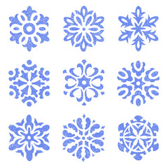 Set of vintage snowflakes drawn on paper by hand. Blue isolated flakes on a white background. Winter and christmas card. Vector illustration.