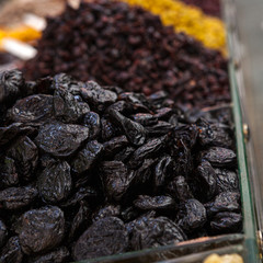 Mix of dried and sun-dried fruits, dried fruits in a wooden box on a white wooden background. View from above. Symbols of the Jewish holiday of Tu B'Shvat