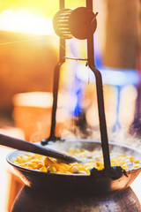 Boiling yellow silkworm cocoons by boiler to make silk thread.