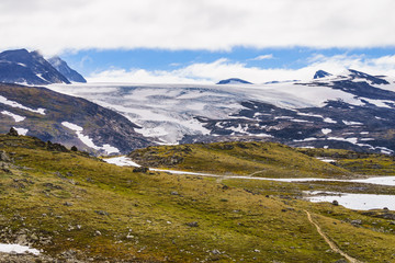Fototapeta na wymiar Mountains with ice glacier. Road Sognefjellet, Norway