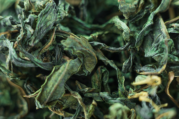Close-up - collection of dried green tea leaves .Top view. Macro photo.