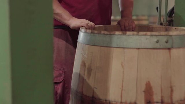 Cooper moving unfinished barrel, close up