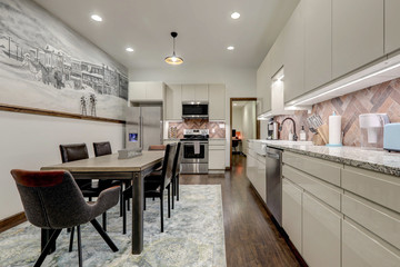 Amazing grey, beige and aqua home kitchen and dining space in a loft vacation home with mural and natural modern rustic design.
