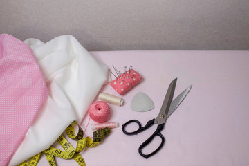 Materials and accessories for handmade. The process of hand sewing with fabric, scissors, accessories for sewing.