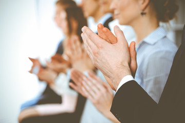 Business people clapping and applause at meeting or conference, close-up of hands. Group of unknown...