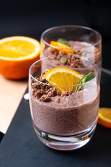 Healthy food concept Chia chocolate orange pudding with granola and pumpkins seed topping in the glasses