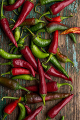 red chilli and green chilli on wood background