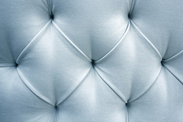 Headboard photo at close range. Upholstery headboard with straps and pleats.