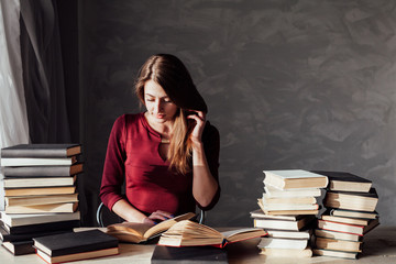 girl reading a book in the library is preparing for the exam