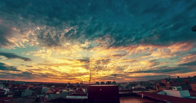 Misty colorful sunset with the sun illuminating the clouds. 4K timelapse.