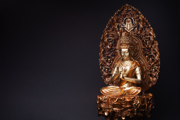 Statue of bronze of Bodhisattva Guan Yin (Avalokiteshvara) sitting in the lotus position, having put hands in knowledge-mudra.