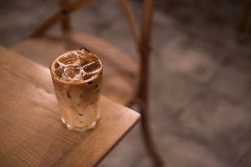 ice latte coffee in plastic cup put on wooden table, christmas theme background