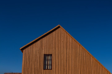 Wooden minimalist house facade with window