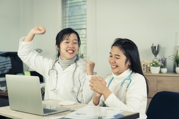 Medical student,Online doctoring,teenage doctor intern working healthcare medical teamwork,Happy with online treatment results satisfactory on laptop desk consultation in hospital with stethoscope