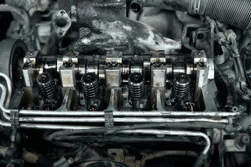 Dismantled car engine under bonnet with dirty details