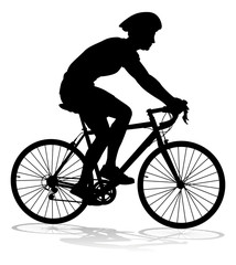 Obraz premium Bicyclist riding their bike and wearing a safety helmet in silhouette
