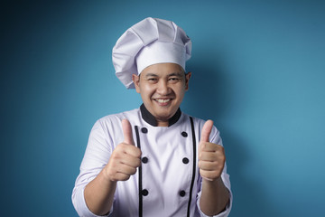Asian Chef Smiling at Camera and Shows Thumbs Up Gesture