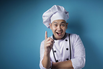 Happy Asian Chef Smiling With Pointing Finger Up, Having Idea Gesture