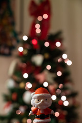 Baby Santa Claus with light-bokeh in the background