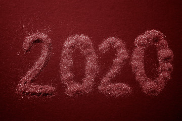 2020 text pattern on red table, top view.