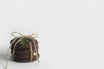 A stack of chocolate cookies on a white background. Beautiful background with a Christmas mood.