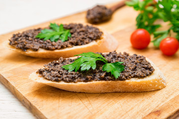 Fresh tasty bruschetta with truffle sauce, parsley and tomates