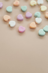 Fototapeta na wymiar Conversation candy hearts on pink background, copy space, valentines background photo