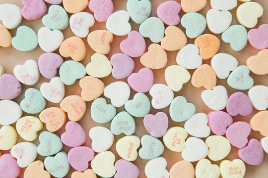 Conversation candy hearts on pink background, copy space, valentines background photo