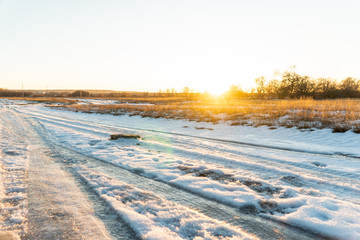 yellow withered grass in the setting sun under the first snow