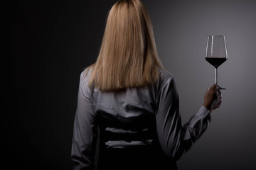 Women somelier tasting wine, drinking wine, holding glass