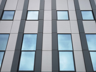Windows with sky reflection. Generic elements of modern office architecture with linear pattern of...