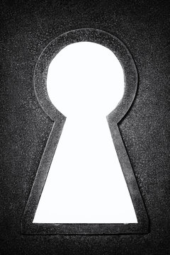 Black and white photo of a rusty metallic keyhole isolated on the white background
