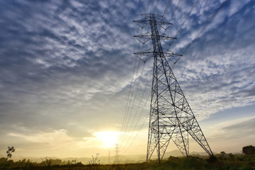 pylon A high voltage of transmission tower in the morning sunrise with the beauty of a blue sky. Copy space.