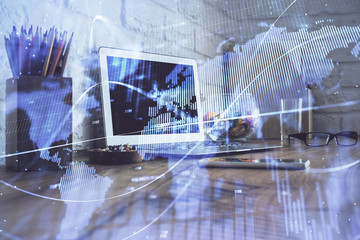 Double exposure of chart and financial info and work space with computer background. Concept of international online trading.