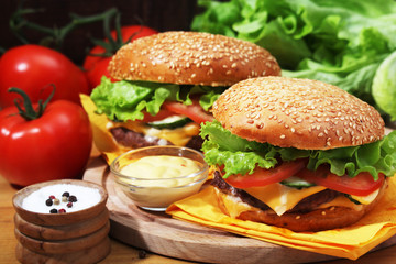 Two fresh hamburgers with vegetables	