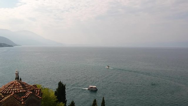 Pull Back Aerial View on Ohrid Lake North Macedonia and St John at Kaneo Orthodox Church Landmark on Coast