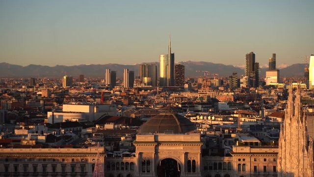 Italy , Milan december 13,2019 - Amzing view of the downtown of the city from Terrazza Martini rooftop during the sunset - Duomo cathedral , Vittorio Emanuele Gallery and skyline with new skyscepers  