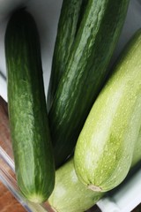 Fresh cucumbers and zucchini on the table