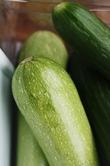 Fresh cucumbers and zucchini on the table