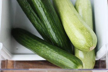 Fresh cucumbers and zucchini on the table
