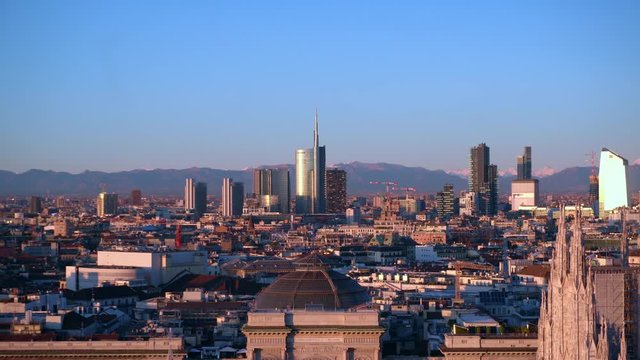 Italy , Milan december 13,2019 - Amzing view of the downtown of the city from Terrazza Martini rooftop during the sunset - Duomo cathedral , Vittorio Emanuele Gallery and skyline with new skyscepers  