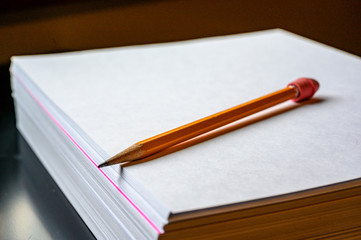 Single colored sheet in a stack of plain white paper